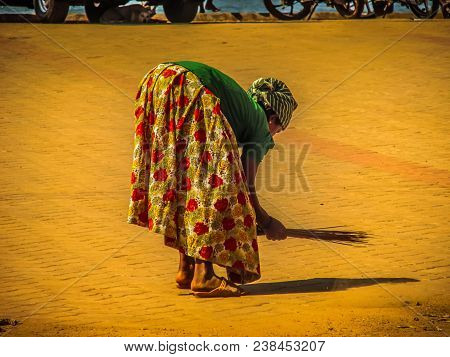 Unknown Woman Cleaning The Street Of Palolem In Goa India October 25-2017 On The Morning