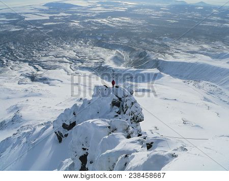 Instructor In Mountaineering In A Red Jacket On Top Of The Mountain Of Kozelsky Volcano In The Kamch