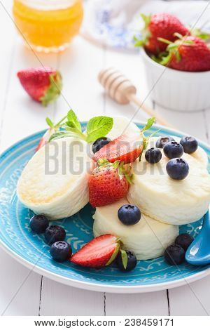 Mini Cheesecake With Berry Fruits On A Blue Plate. Cold Summer Dessert Or Snack. Healthy Cottage Che