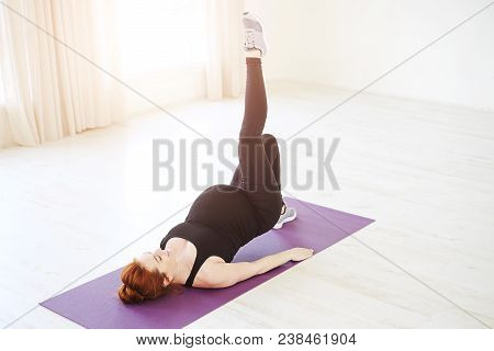 Beautiful Pregnant Woman Practicing Prenatal Yoga Or Pilates Lying On Back Exercising With Upper Bod