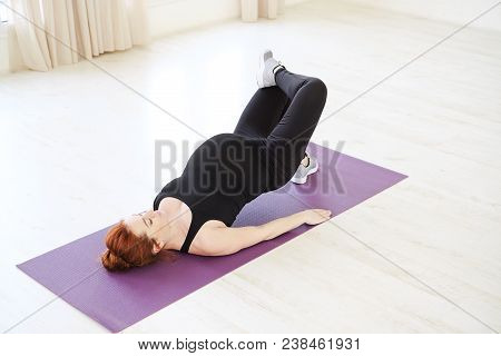 Beautiful Pregnant Woman Practicing Prenatal Yoga Or Pilates Lying On Back Exercising With Upper Bod