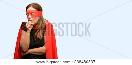 Middle age super hero woman wearing red mask and cape sick and coughing, suffering asthma or bronchitis, medicine concept isolated blue background