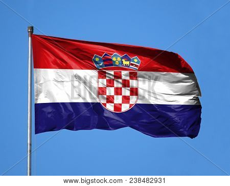 National Flag Of Croatia On A Flagpole In Front Of Blue Sky.