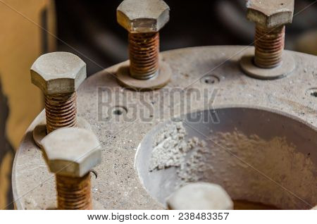 Old Rusty Bolts In The Dust On The Pipe Joint
