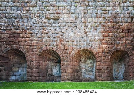 Heavily Fortified Castle Ruins Located On A Dramatic Promontory Overlooking The River Esk.