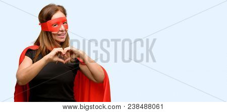 Middle age super hero woman wearing red mask and cape happy showing love with hands in heart shape expressing healthy and marriage symbol isolated blue background