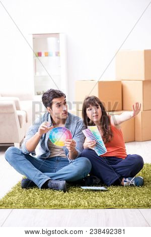 Young family choosiing colours for new apartment