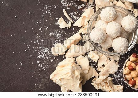 White Crushed Chocolate Pieces On Dark Background, Truffles In Coconut Flakes And Rhazelnuts Bowl, C