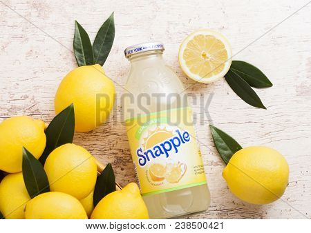 London, Uk - April 27, 2018: Bottle Of Snapple Lemon Juice On Wooden Background With Fresh Lemons.sn