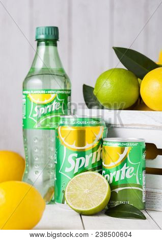London, Uk - April 12, 2017: Bottle And Aluminium Can Of Sprite Drink On Wooden Background With Lemo
