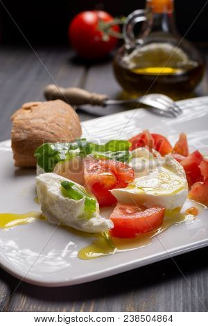 Caprese Salad With Tomatoes, Basil,  Mozzarella Balls, Made With White Ball Mozzarella Buffalo Itali