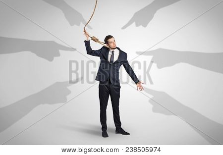 Young businessman trying to suicide with pointing hands concept