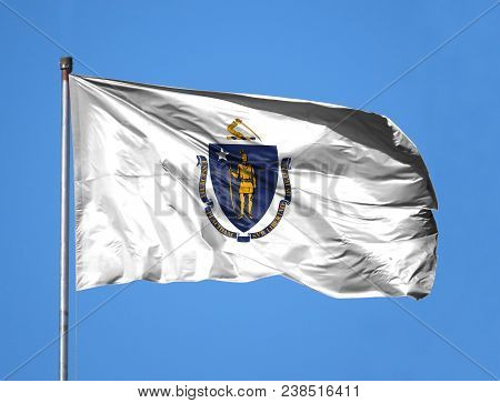 National Flag State Of Massachusetts On A Flagpole In Front Of Blue Sky.