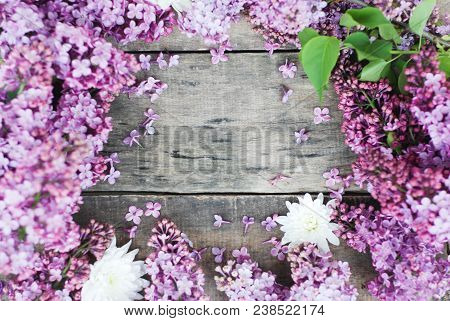 Purple Spring Lilac Frame Over Rustic Textured Wooden Board Isolated