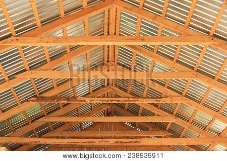 The Interior View Of The Construction Of A Pitched Roof Showing The Ridge, Rafters And Sheathing.