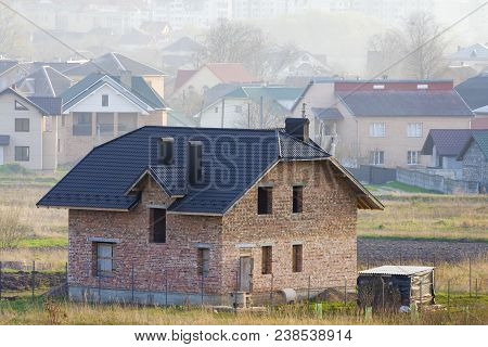 Brand New Spacious Brick Two Story Residential House With Tiling Roof And Windows Openings In Suburb