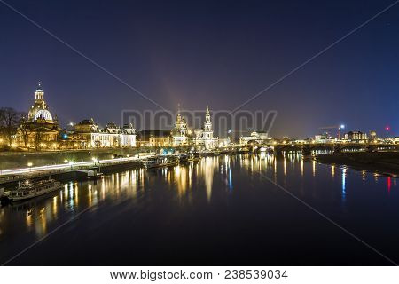 Night Cityscape View Of Historic Buildings With Reflections In Elbe River In The Center Of Dresden (