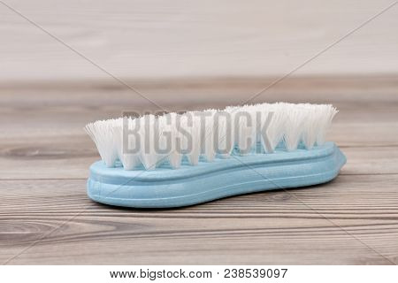Blue Plastic Brush On Wooden Background. Blue Scrubbing Brush. Washing Brush On Wood.