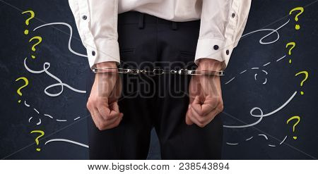 Now arrested men with handcuffs and chalk drawn question signs and lines around
