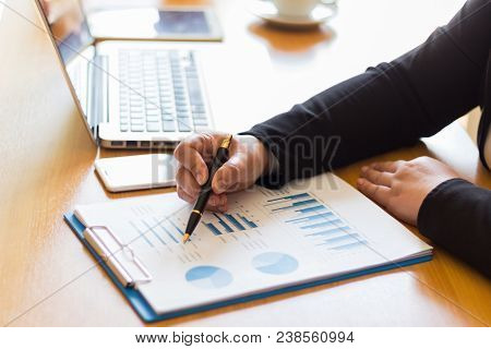 Businessmen Sit And Analyze Graphs In The Office.