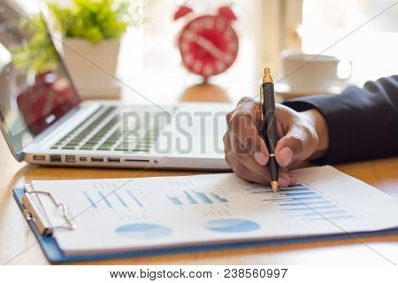 Businessmen Sit And Analyze Graphs In The Office.