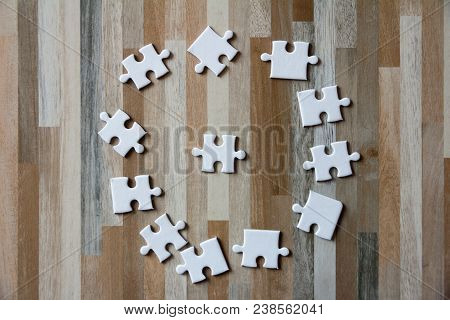 White Jigsaw Puzzle Put On Wood, Teamwork Concept