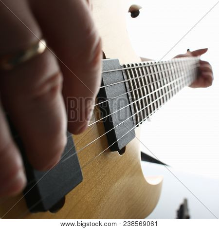 Male Hands Playing Electric Guitar On Maple Fretboard Closeup Photo. Learning Musical Instrument Tra