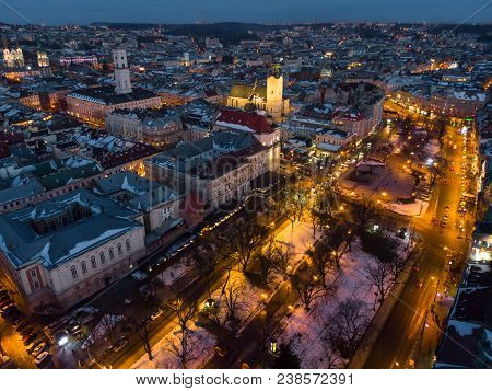 Aerial View Of City In Night Time. Streets In Car Lights.