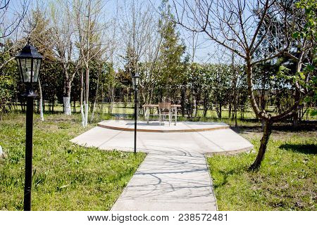 A Picnic Table On A Summer Day With A Bright Blue Cloud Filled Sky In The Background And Room For Yo