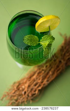 Green Khus Sharbat Or Vetiver Grass Extract Or Chrysopogon Zizanioides Served In Tall Glass With Min