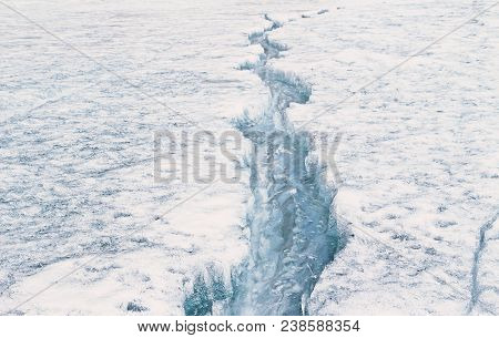 Large And Long Cracking Line In Ice Lake, Sign Of Beginning Of Spring Season