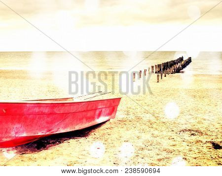 Abstract Effect.  Abandoned Red Paddle Boat On Sandy Beach Of Sea.  Smooth Water Level Within Mornin