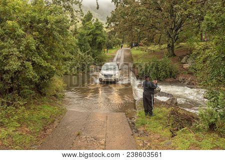Royal Natal National Park, South Africa - March 17, 2018: A Car Crossing The Mahai River At The Maha