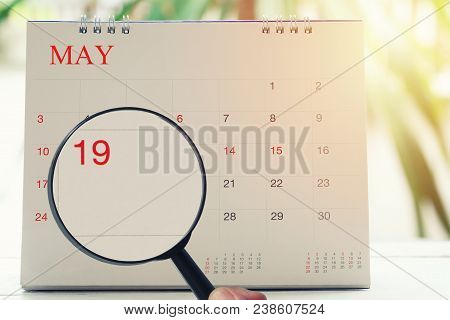 Magnifying Glass In Hand On Calendar You Can Look Nineteenth Day Of Month,focus Number Nineteen In M