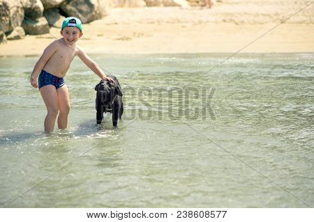 Littl Boy Is Running Along The Beach Playing And Splashing In Water Of Adriatic Sea In Durres, Alban