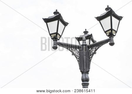 Black Metal Lantern With Two Tourist Sign In A Green Park. Black Lantern In A The Background Of Tree