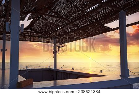 Scenic View Of Sandy Beach On The Beach With Sun Beds And Umbrellas Open Against The Sea And Mountai