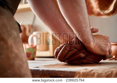 Hands Of Male Potter Molding A Clay In Pottery Workshop, Close-up, Selective Focus. Creative Work Pr