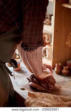 Hands Of Male Potter Molding A Clay In Pottery Workshop, Close-up, Selective Focus. Creative Work Pr