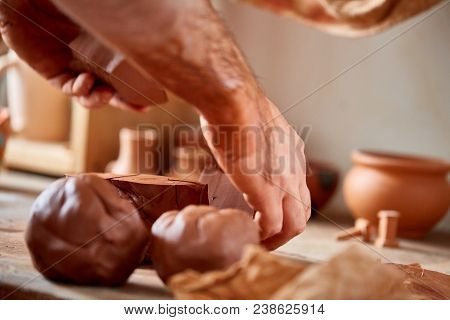 Hands Of Male Potter Molding A Clay In Pottery Workshop, Close-up, Selective Focus. Creative Work Pr