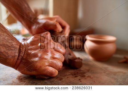 Hands Of Male Potter Molding A Clay In Pottery Workshop, Close-up, Selective Focus. Creative Work Pr