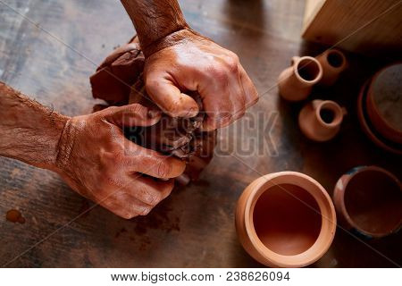 Hands Of Male Potter Molding A Clay In Pottery Workshop, Close-up, Selective Focus. Creative Work Pr