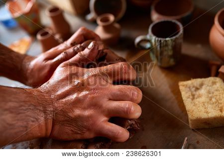 Hands Of Male Potter Molding A Clay In Pottery Workshop, Close-up, Selective Focus. Creative Work Pr