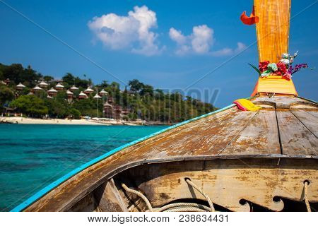 Photo Taken From A Thai Long-tail Boat Floating On An Emerald Sea With A Bungalow Resort At Koh Phi 