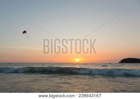 Beautiful Flight With A Parachute Over The Sea At Sunset. Paraseyling. Thailand. Active Rest.