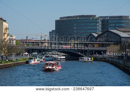 Berlin Germany - April 20. 2018: Tour Boats On The Spree River With Train Station And Buildings In T