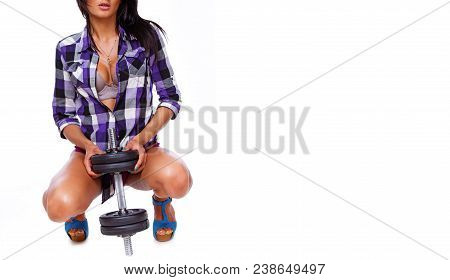 Portrait Of Sexy Brunet Posing In Studio With Dumbbells