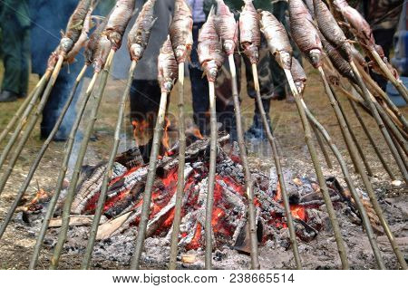 Fish On Grill In The Fish Festival. Bake On Fire Bonfire.food Celebration In Nature. Food And Fire.