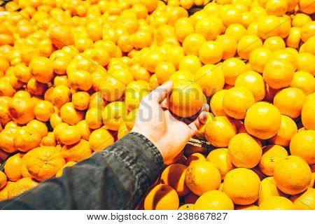 First-person View. Man Takes Orange In Store. Grocery Shopping Concept