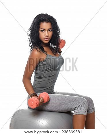 Exercising With Fitness Ball. Side View Of Wooman Sitting On Fitness Ball And Doing Exercises With D